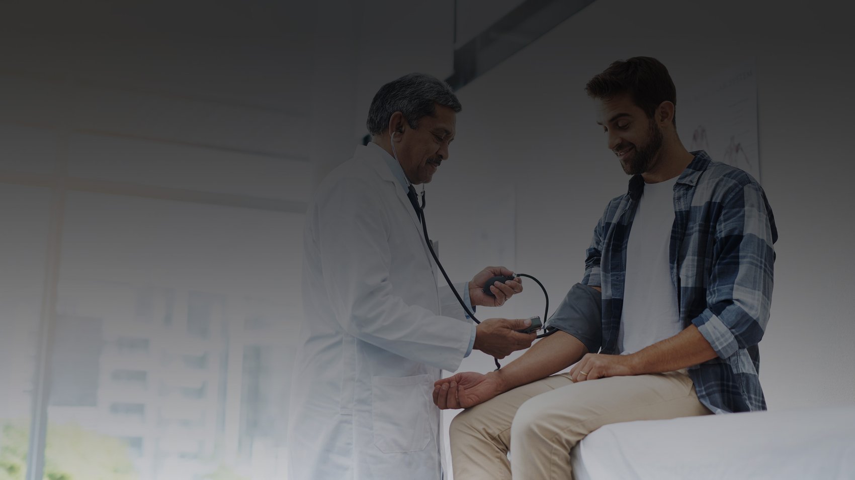Doctor showing doctor taking patient's blood pressure